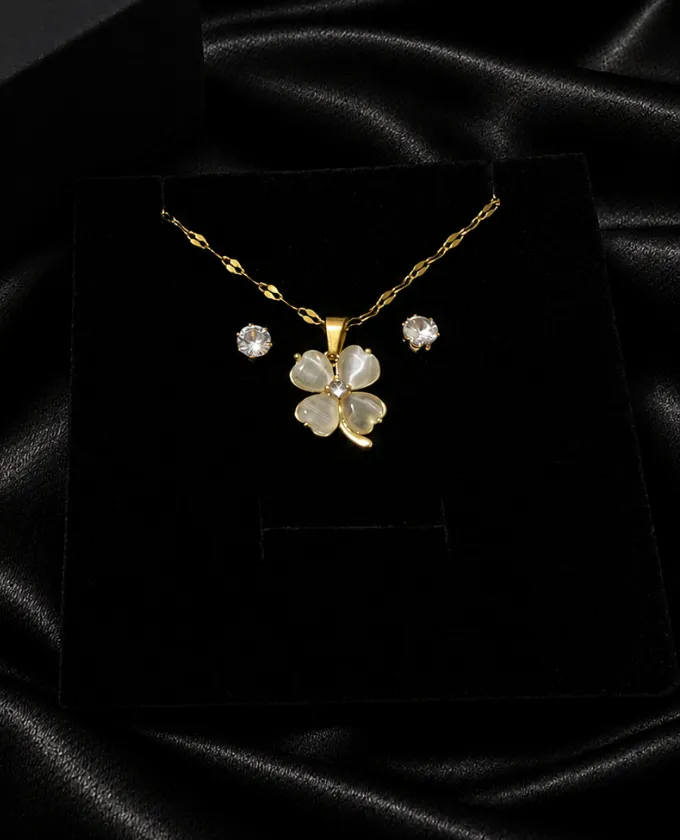 Gold clover necklace with pearlescent petals and crystal studs